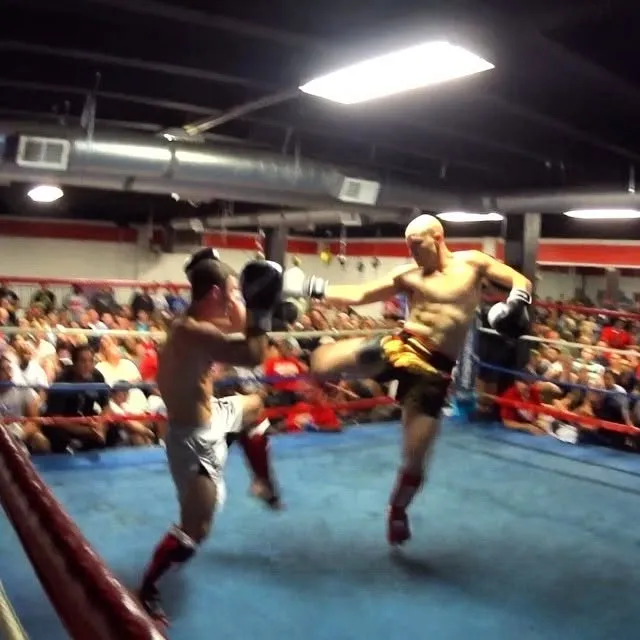 Eitan mid-fight in the ring, crowd all around