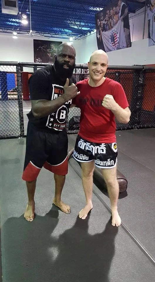 Eitan posing with Kimbo Slice by the cage